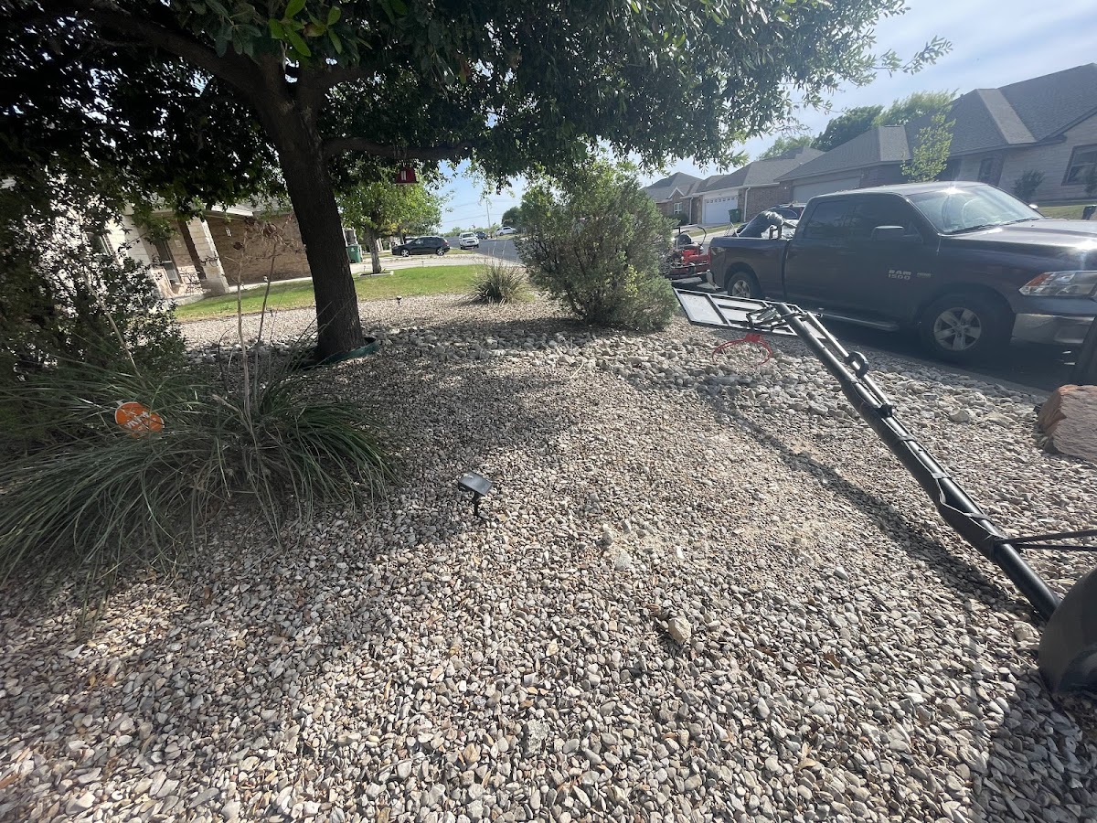 Garza Lawn Care truck and trailer set up at a job site